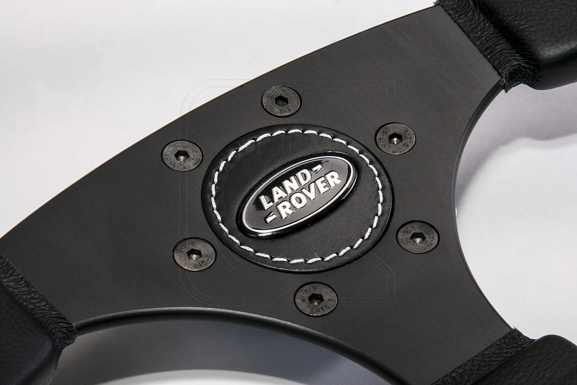 Close up of black Land Rover steering wheel centre
