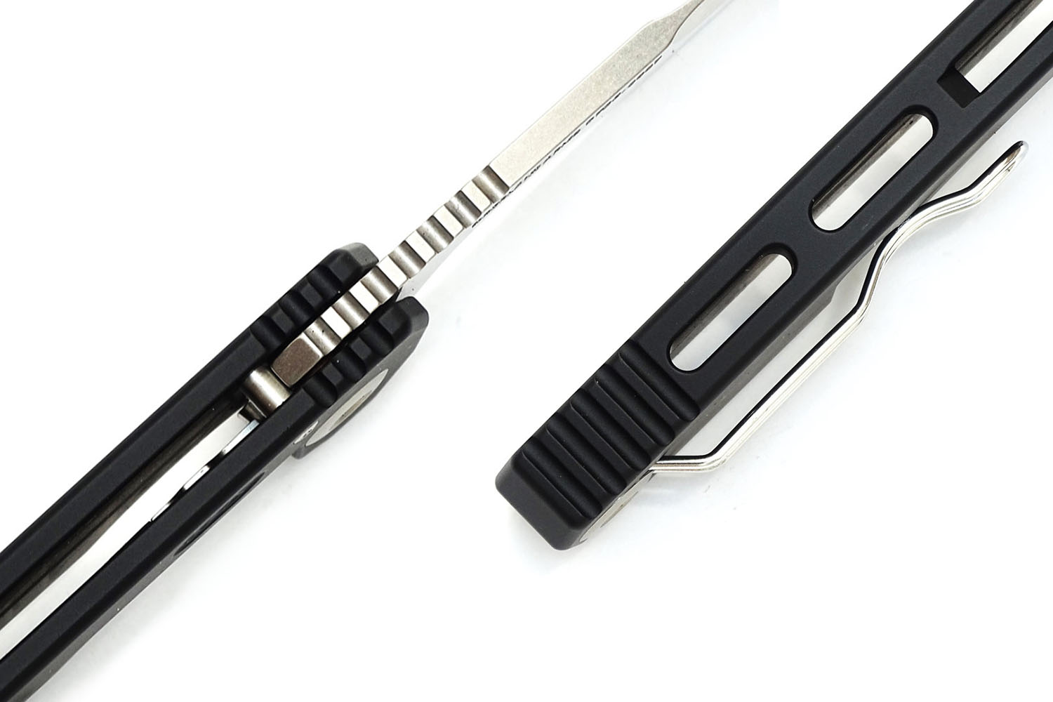 Detail of black folding knife spine and pocket clip